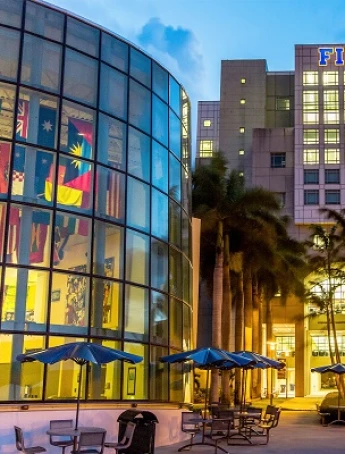 Modern university building with palm trees